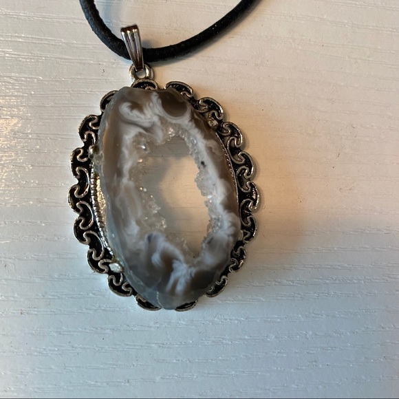 Jewelry - Geode pendant mounted on antiqued gold tone ornate metal base with leather cord.